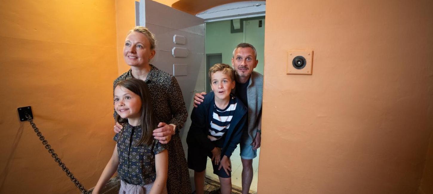 Familie betrachtet eine Gefängniszelle etwas genauer