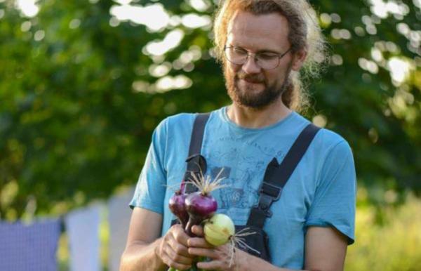 Søren Sørøver vom Brandbygegaard präsentiert feine, frisch geerntete Zwiebeln im Garten nahe Alrø in Odder