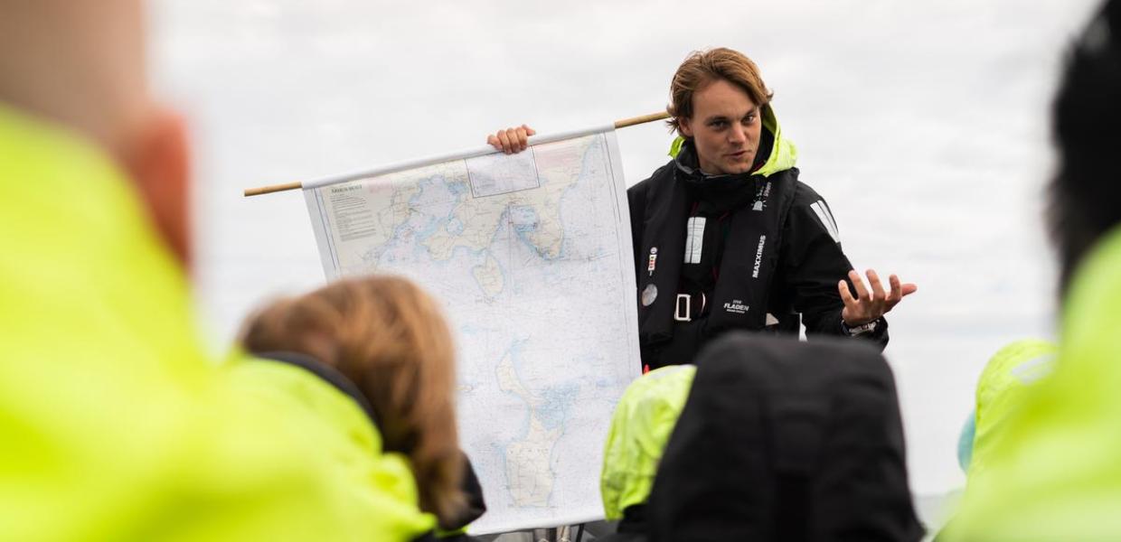 The World's Tiniest Cruise in The Coastal Land in Denmark Tour Guide holds a map
