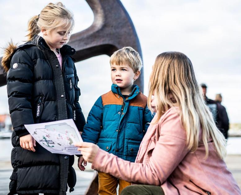 Eine Mutter und ihre Kinder auf Schatzsuche in Juelsminde